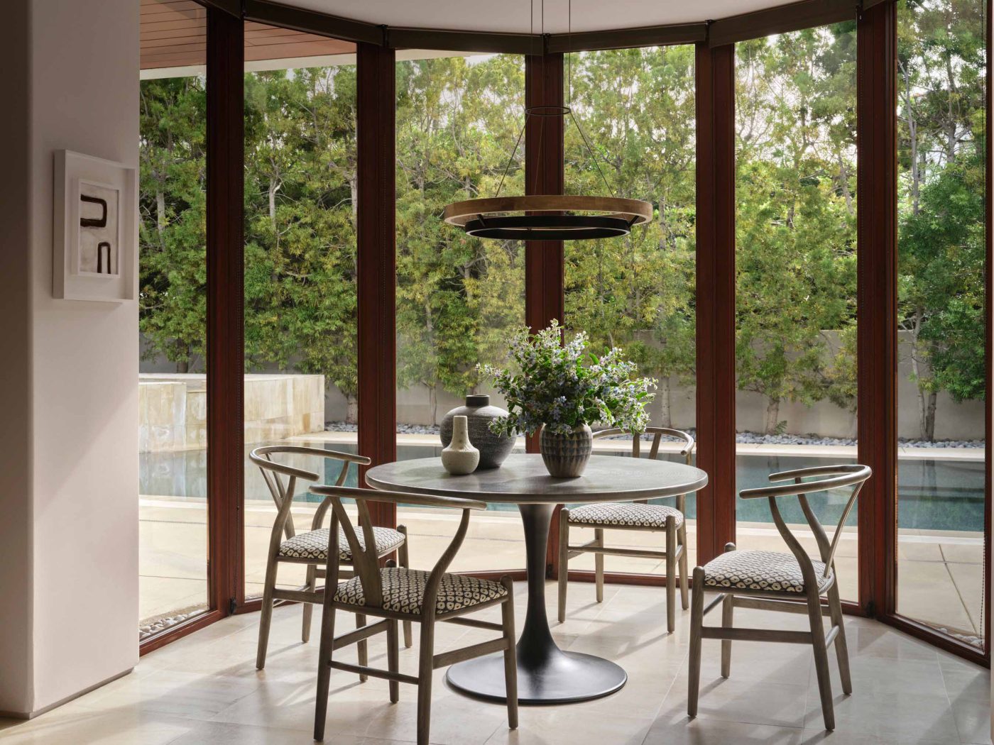 Round table in a bay of windows overlooking the pool