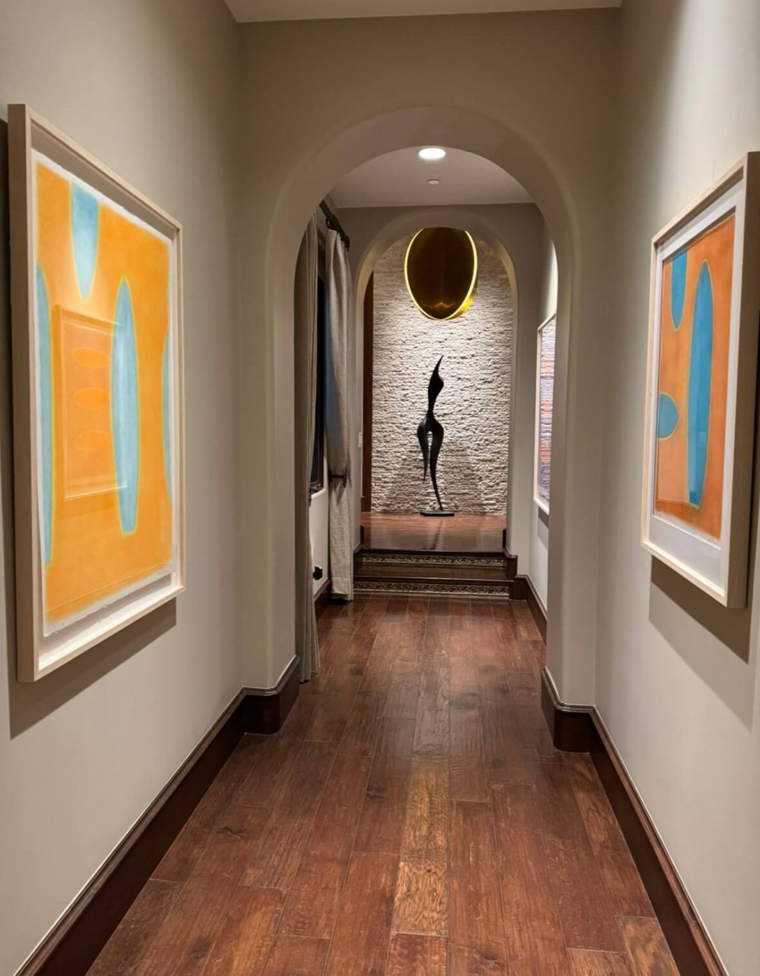 Hallway lined with Lori Brunner paintings from the Love Letter to La Jolla collection