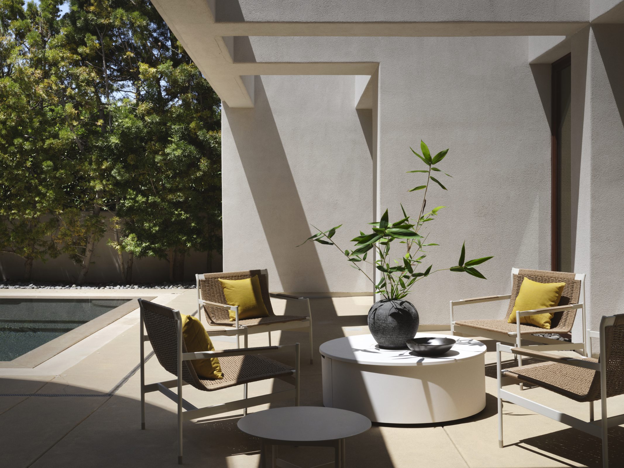 Covered patio with lounge chairs beside the pool, photographed by Douglas Friedman